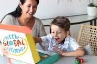 boy opening Little Global Citizens box