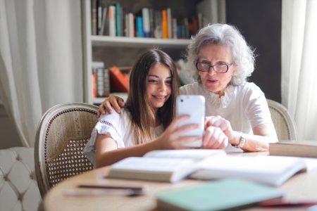 Staying in touch like the grandma and granddaughter in the photo is one of the best ways to cope with empty nest syndrome.