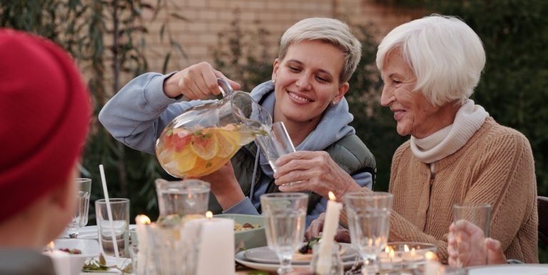 A daughter pouring her mother iced tea