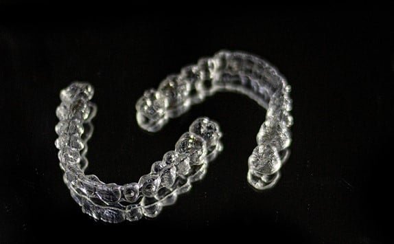 pair of aligners on a black background